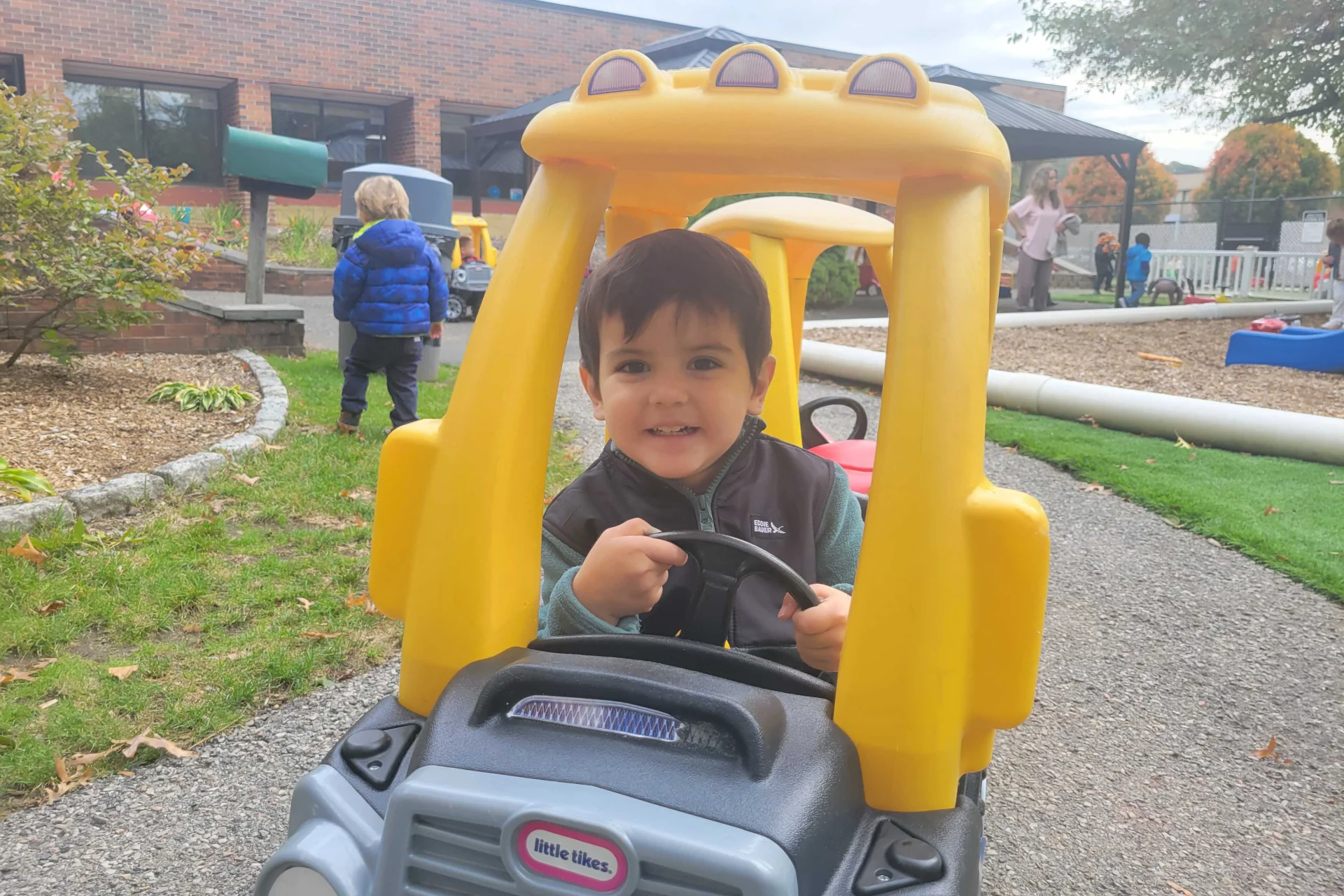 toddler playing outdoors at his daycare